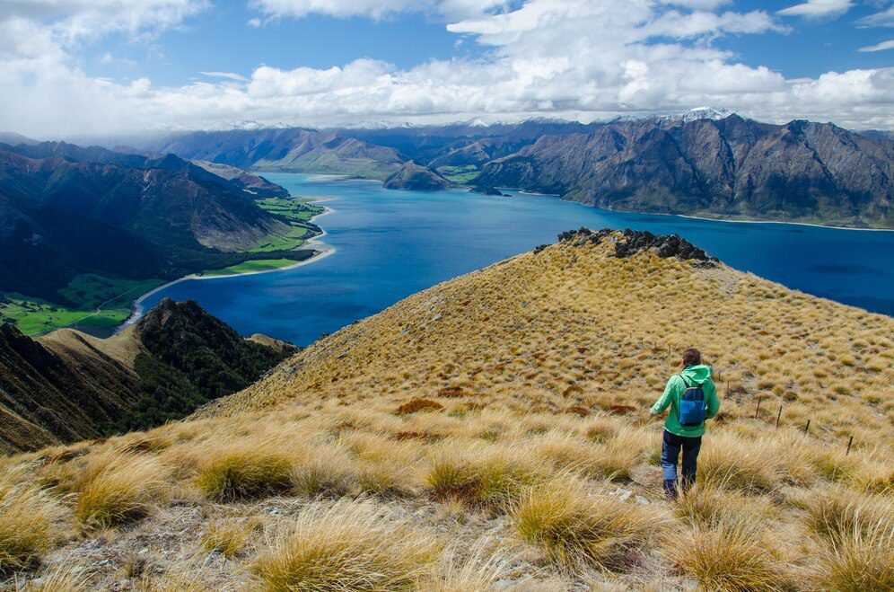 A woman hiking along Isthmus Peak with scenic lake views