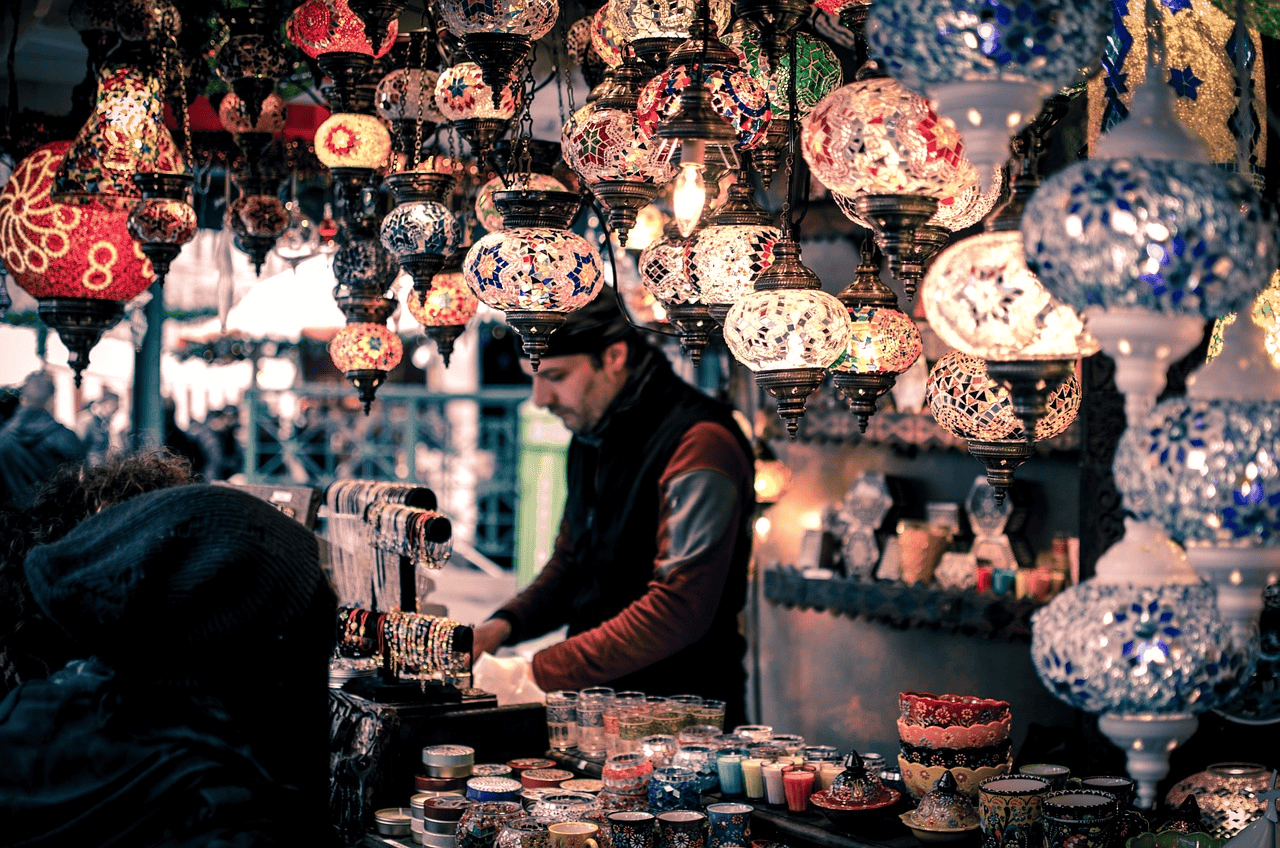 Bazaar booth displaying bracelets and candles in Turkish markets