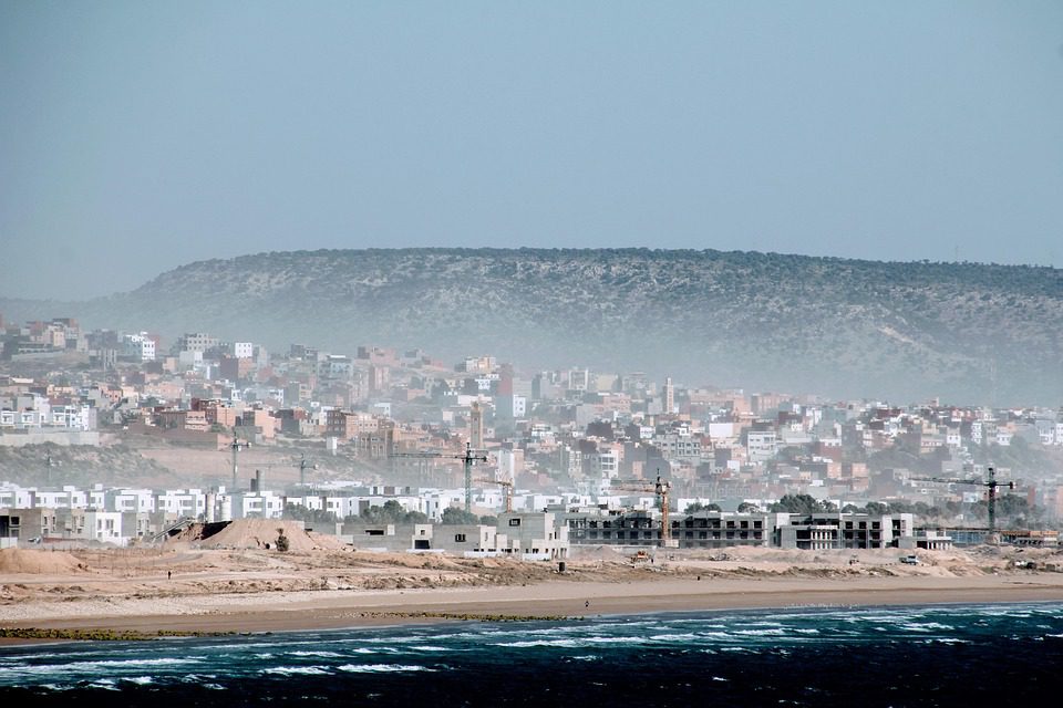 Coastal view of a Moroccan beach with historic buildings
