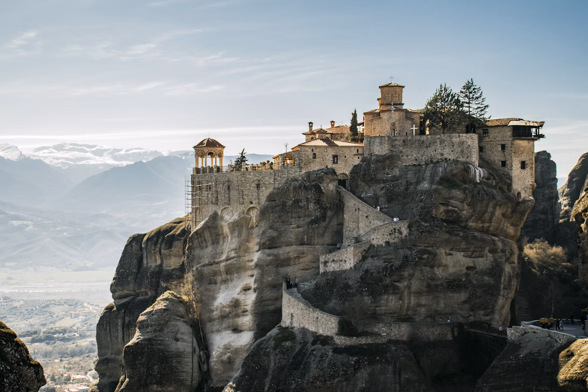 Monasteries of Meteora perched on rock pillars amid early autumn landscape
