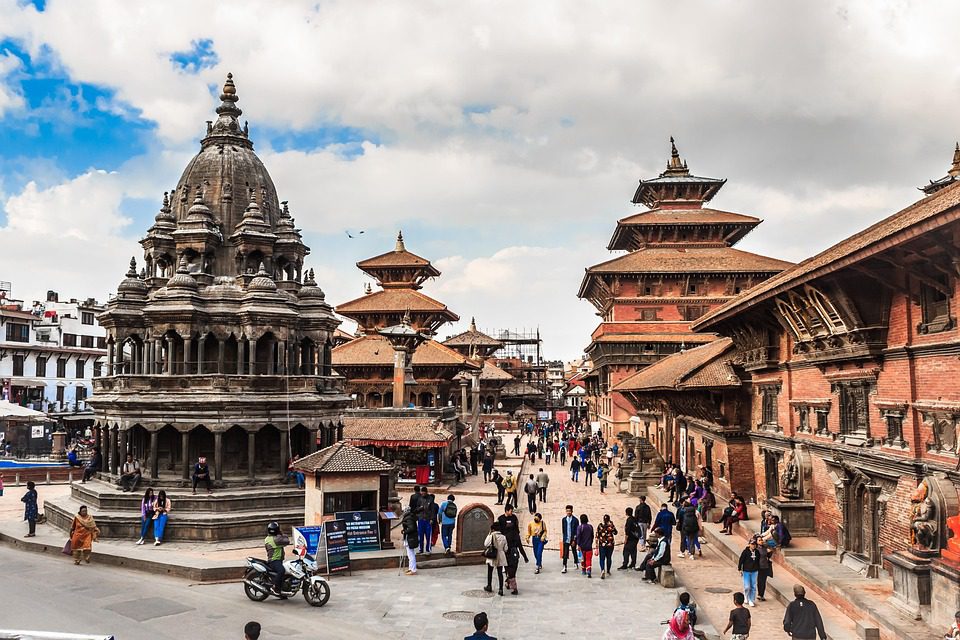Temple and palace at Durbar Square bustling street