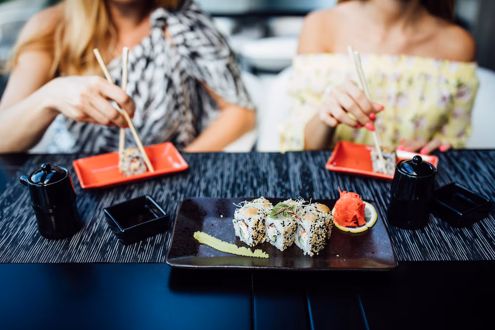 Two people enjoying traditional sushi in Japan